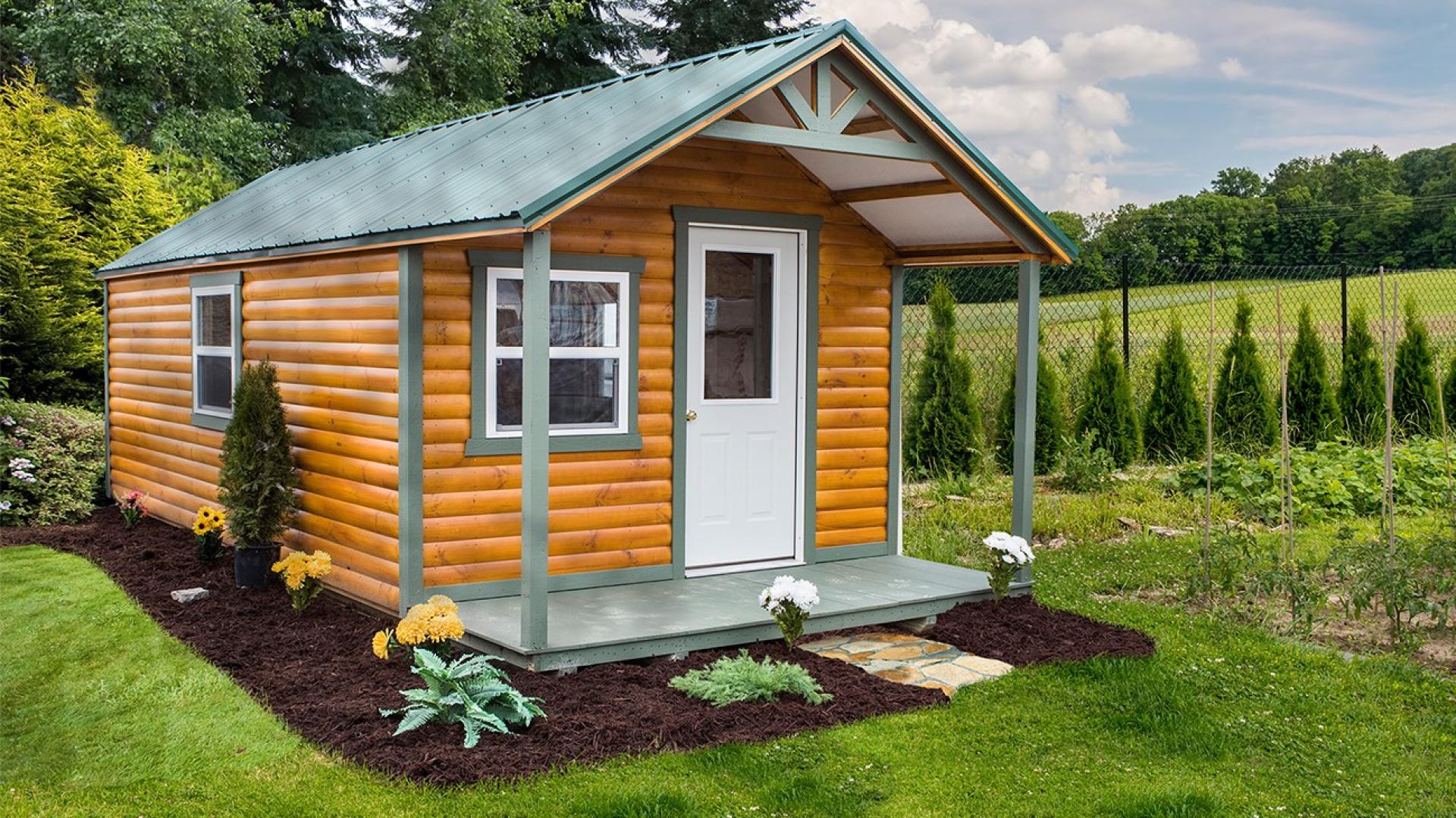 Brown hunting cabin with green roof and trim
