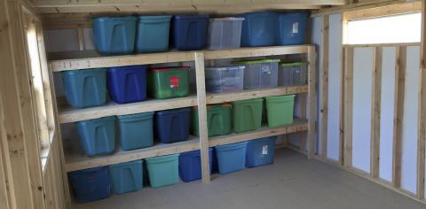 Storage tote shelving inside shed